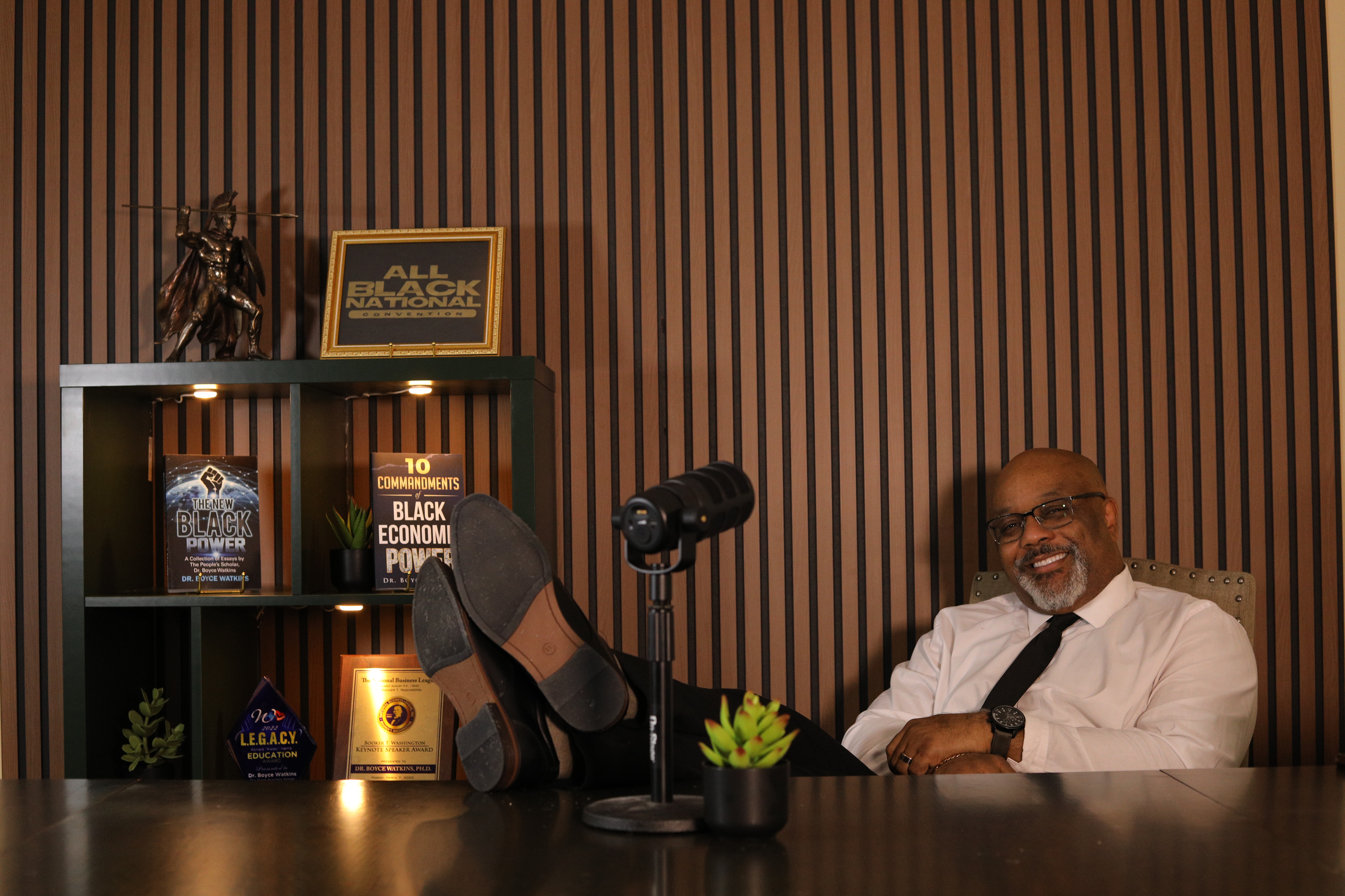 Dr. Boyce Watkins in studio with books